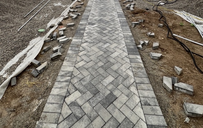 Herringbone paver walkway under construction