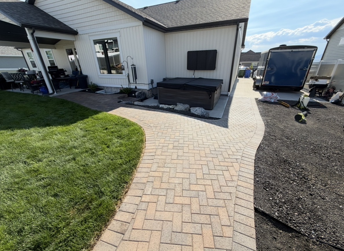 Finished custom paver walkway around a home